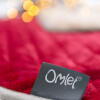 omlet label on a red luxury blanket for cats and dogs