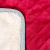 A close up photo of a soft red dog bed blanket.