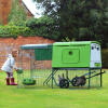 Green Eglu Cube Large Chicken Coop and Run in the garden with girl