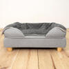 An Omlet bolster dog bed with feet and a luxury soft blanket.