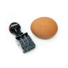 Adjustable Egg Date Stamp next to egg with red date on it.