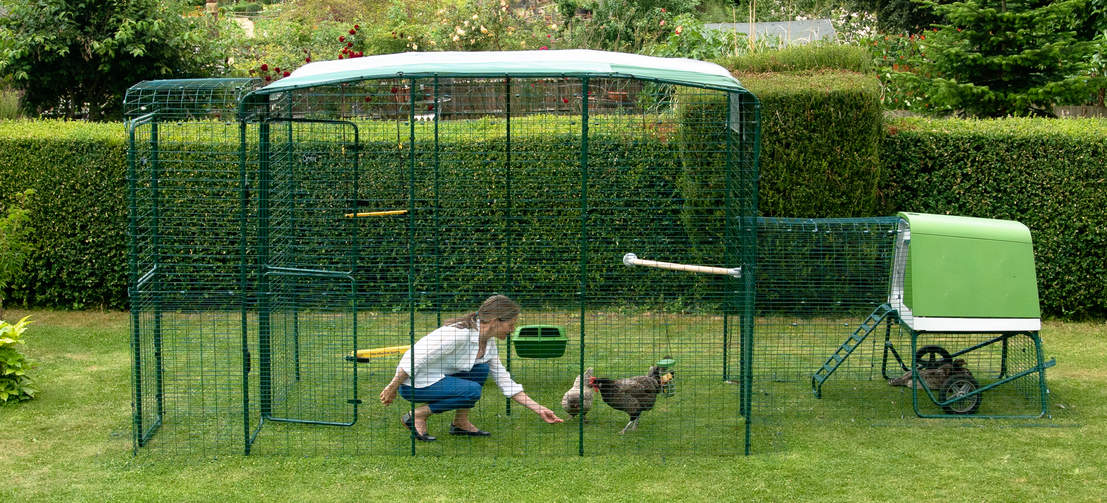 A women in an Omlet walk in chicken run.