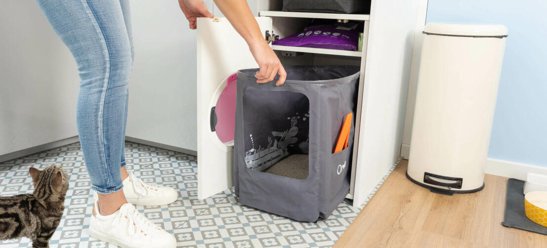 woman cleaning the omlet cat litter box