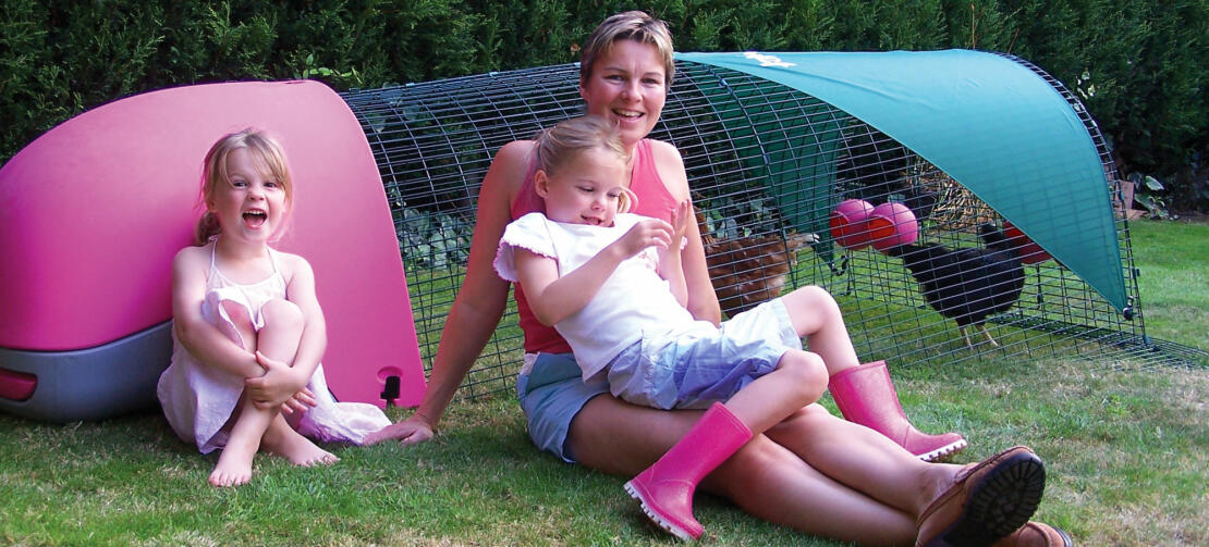 A family relaxing with their chickens