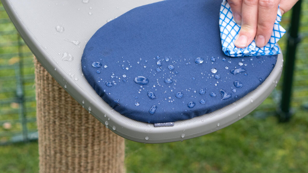 The wet freestyle step and cushion being wiped down with a cloth