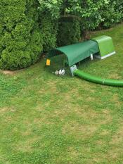 The green heavy duty cover for the Eglu Go attached to the run.