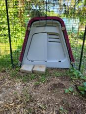 A close up of the Eglu Go chicken coop attached to a walk in run.