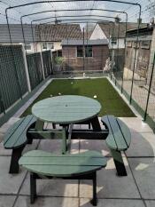 A large catio set up in a garden.