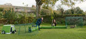 people playing with bunnies in a rabbit run and go hutch setup with a zippi tunnel