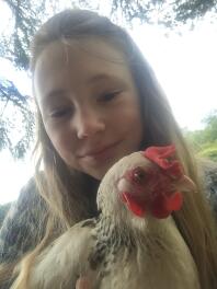 Girl taking selfie with Chicken