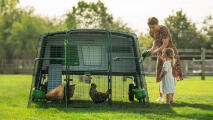 mother and daughter looking at the chickens in the eglu pro coop