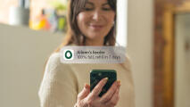 lady receiving a phone notification from her smart chicken feeder