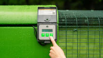 finger pressing the autodoor control panel buttons