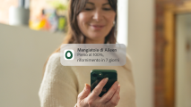 woman receiving omlet app feed level notification to her phone