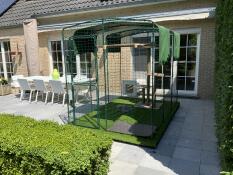 A rabbit in his outdoor enclosure, place on the terrasse of a house