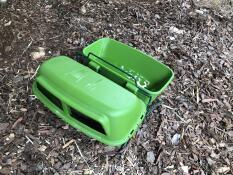 A feeder and drinker attached together using the feeder and drinker stand.