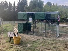 A large enclosure with covers and a perch