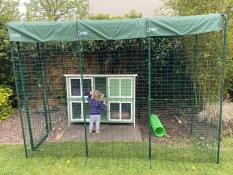 A large rabbit enclosure in a garden