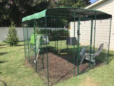 A large covered run connected to a chicken coop