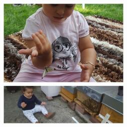 a young girl in a garden with a butterfly sat in a garden