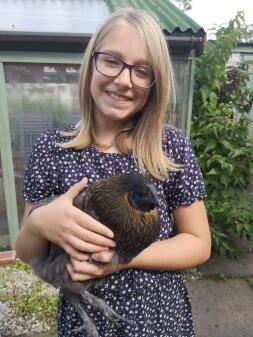 A woman holding her chicken.