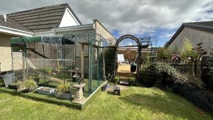 An Omlet catio set up in a garden.