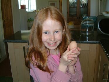 Emily proudly holding our first egg.  we think it came from dorothy.