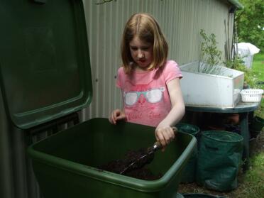 Girl helping the composting