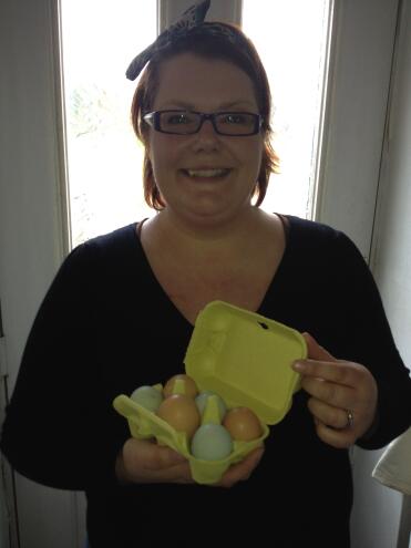 Woman holding yellow egg box