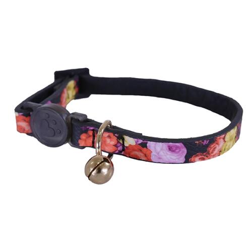 a cat collar with flowers and a bell on it