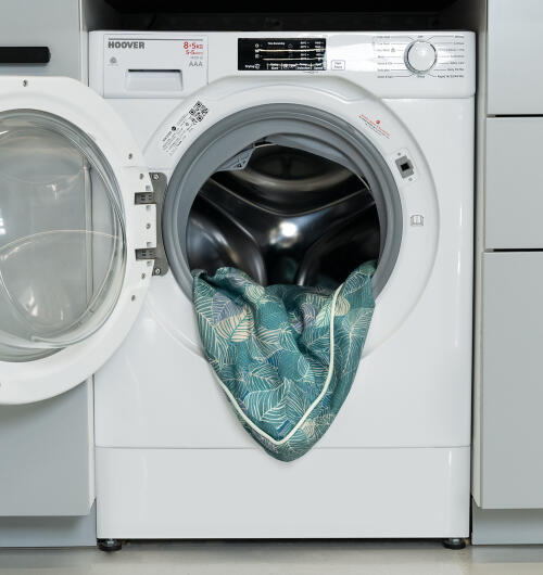 washing machine drum with a dog bed cover inside