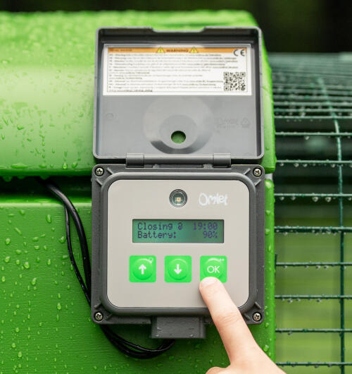 finger pressing buttons on the autodoor control panel
