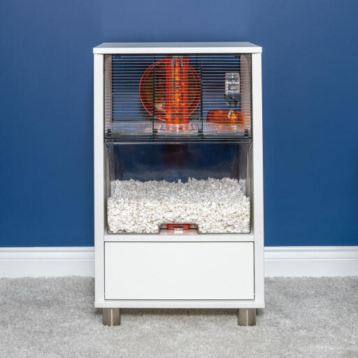 Modern white Qute Hamster and Gerbil cage in a living room.