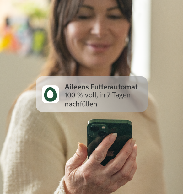 woman receiving omlet app feed level notification to her phone