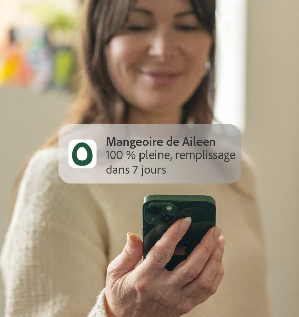 woman receiving omlet app feed level notification to her phone