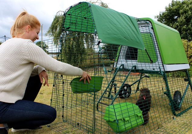 Opening the top door of the Eglu Go UP chicken run.