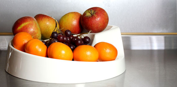 A cream Rollabowl filled with fruit in the kitchen