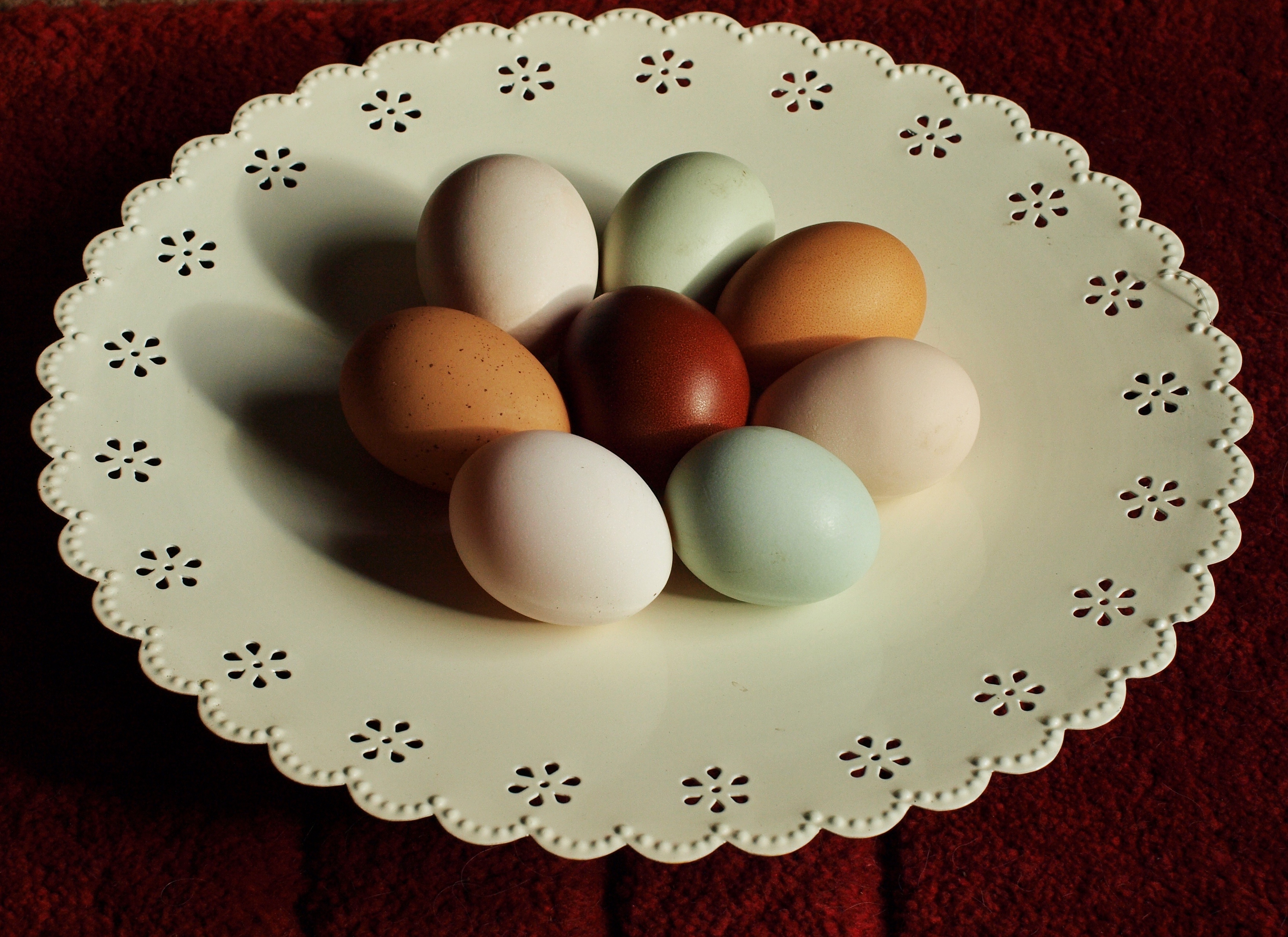 A selection of amazing coloured eggs on a plate.