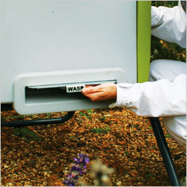 Wasp guard being applied to Beehaus entrance.